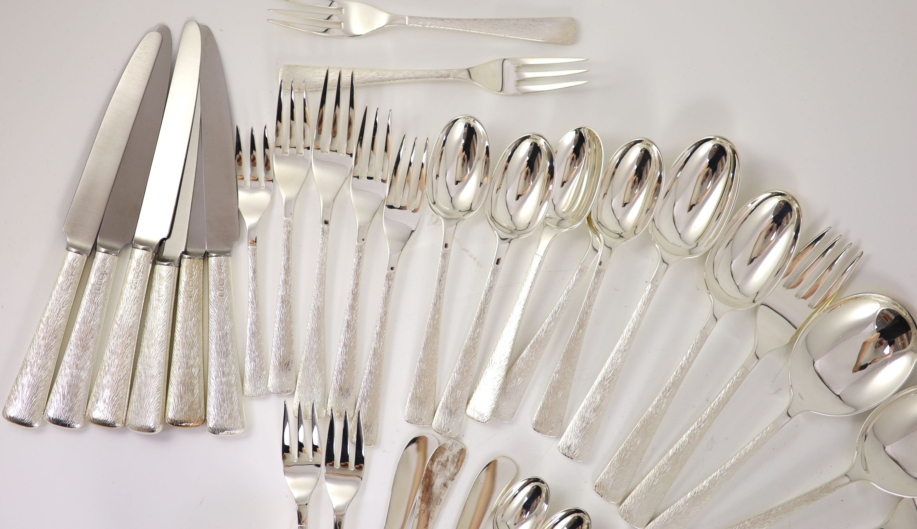 A good part textured silver canteen of cutlery for six by Adrian Gerald Benney